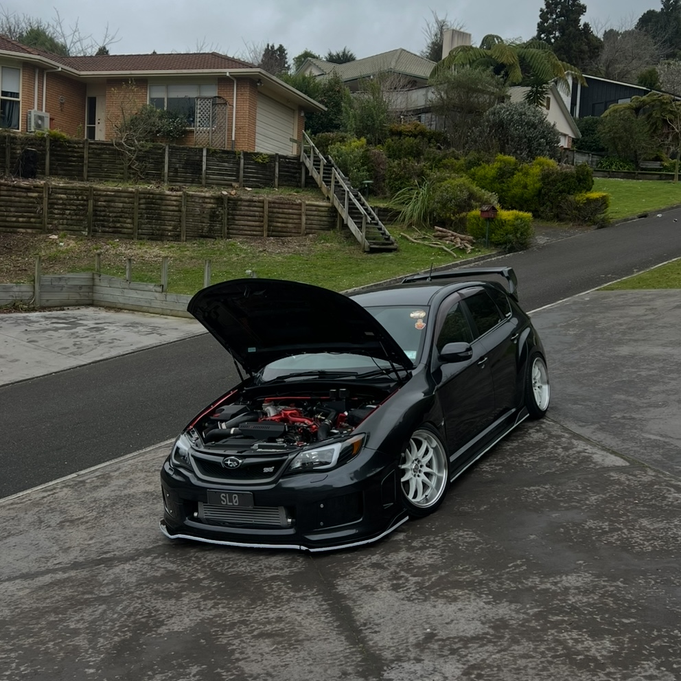 Black Subaru WRX STI hatch with bonnet up
